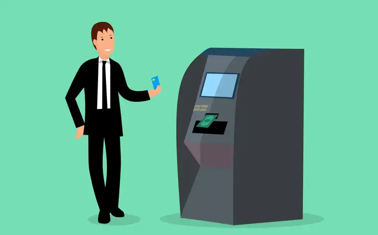 A customer using a crypto ATM terminal with a card in hand